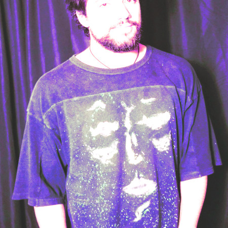 Picture of Lucius Rafi wearing a custom art t-shirt he made.